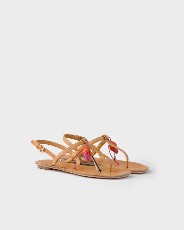 Antiqued leather thong sandals with floral ornament